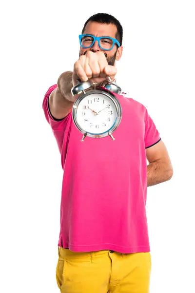 Man with colorful clothes holding vintage clock — Stock Photo, Image
