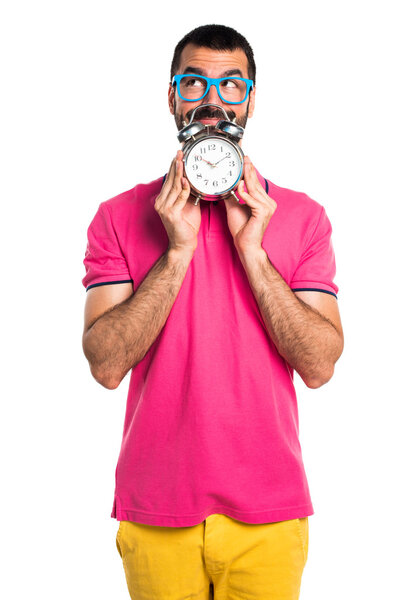 Man with colorful clothes holding vintage clock