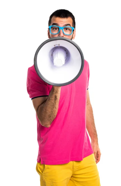 Man with colorful clothes shouting by megaphone — Stock Photo, Image