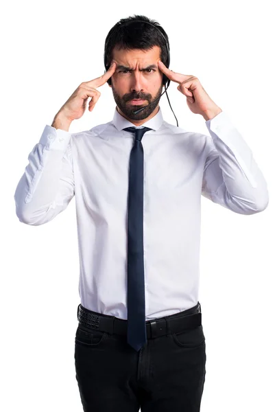 Young man with a headset thinking — Stock Photo, Image