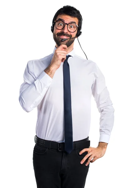 Young man with a headset thinking — Stock Photo, Image