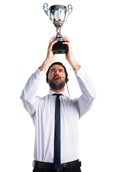 Handsome telemarketer man holding a trophy Stock Image