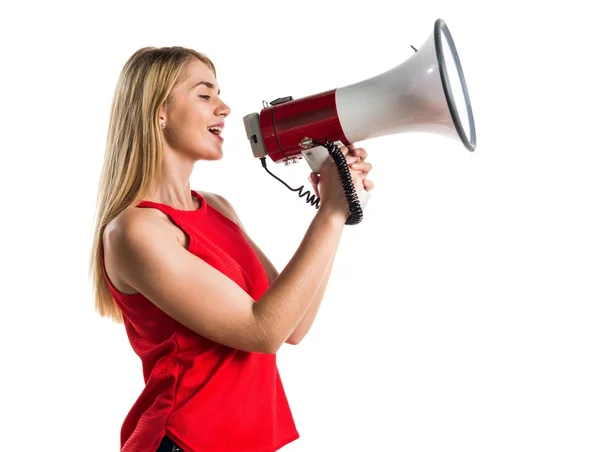 Blonde girl shouting by megaphone — Stock Photo, Image