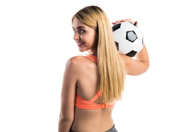Menina loira bonita segurando uma bola de futebol — Fotografia de Stock
