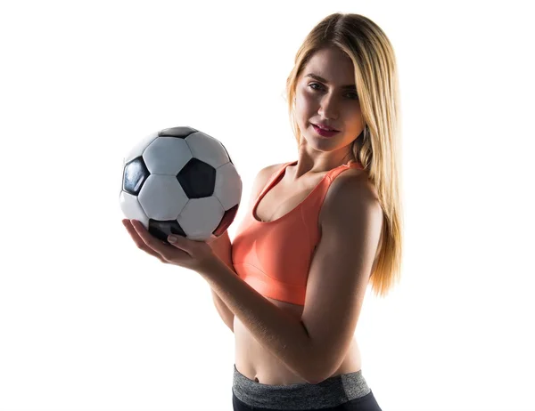 Pretty blonde girl holding a soccer ball — Stock Photo, Image
