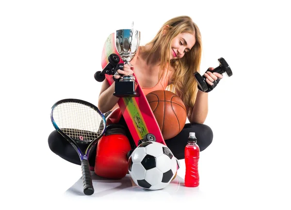 Sport girl with a lot of sport items — Stock Photo, Image