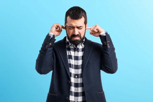 Handsome man covering his ears — Stock Photo, Image