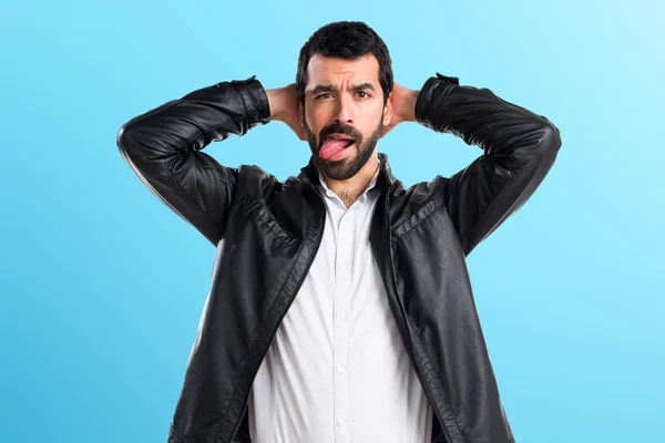 Man with leather jacket taking out his tongue — Stock Photo, Image