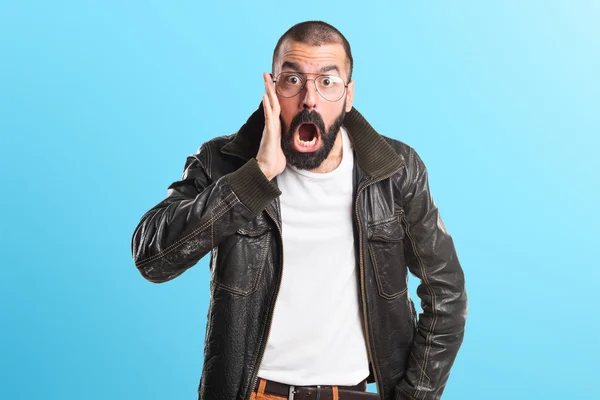 Man wearing a leather jacket doing surprise gesture — Stock Photo, Image