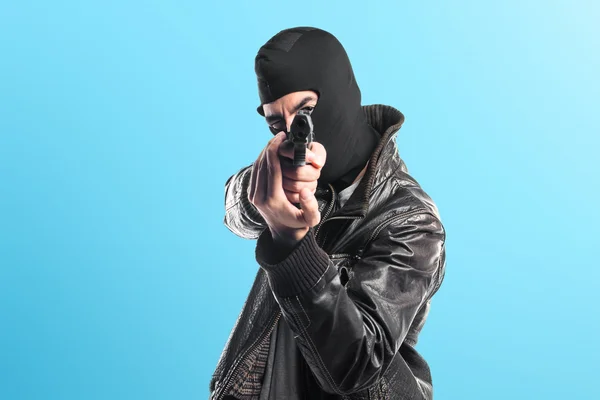 Robber shooting with a pistol — Stock Photo, Image
