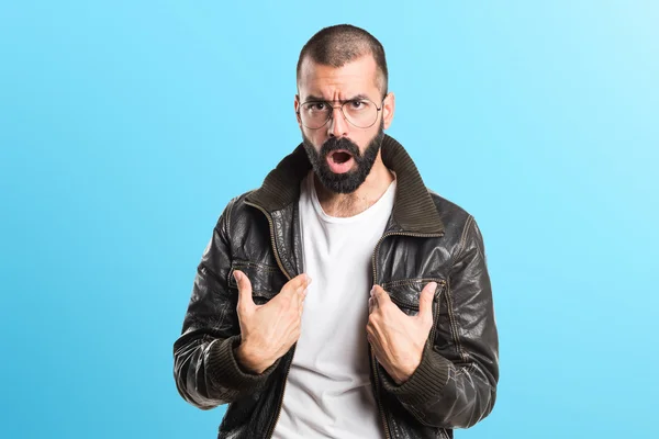 Man wearing a leather jacket doing surprise gesture Stock Picture