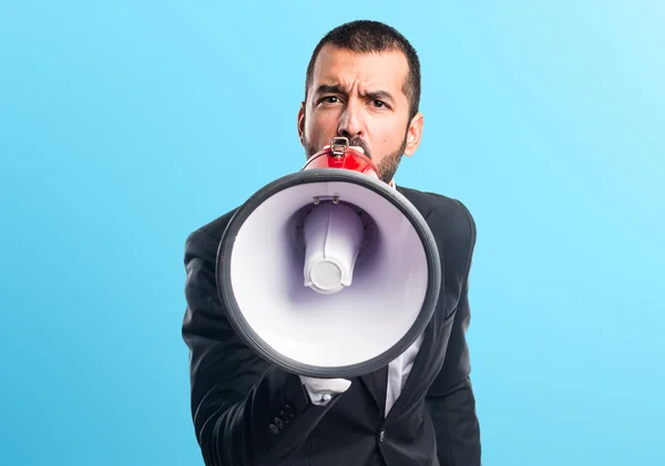 Businessman shouting by megaphone — Stock Photo, Image