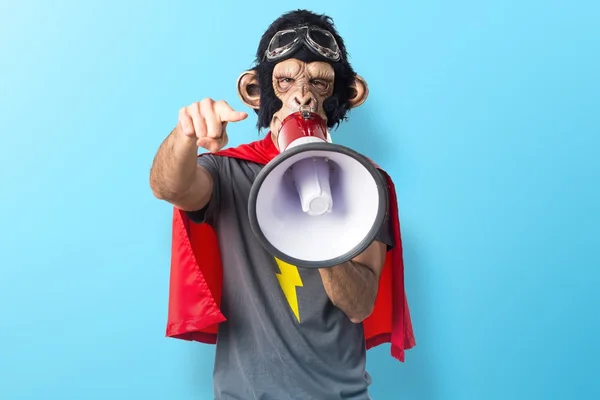 Superhero monkey man shouting by megaphone — Stok Foto