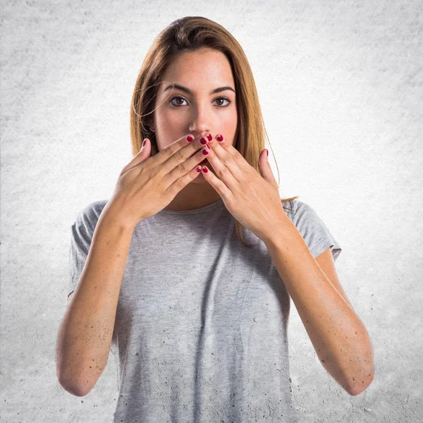 Young girl covering her mouth