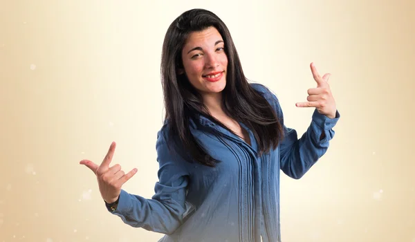 Girl making horn gesture — Stock Photo, Image