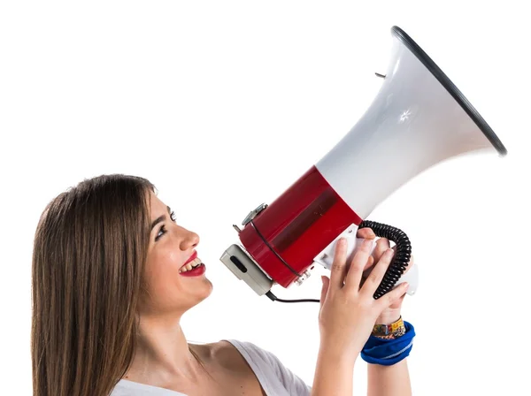 Young girl shouting by megaphone — Stock Photo, Image