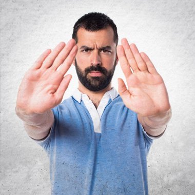 Adam mavi gömlek yapma dur işareti ile