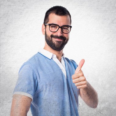 Başparmak ile mavi gömlekli adam