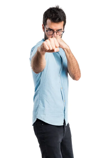 Handsome man with blue glasses giving a punch — Stock Photo, Image