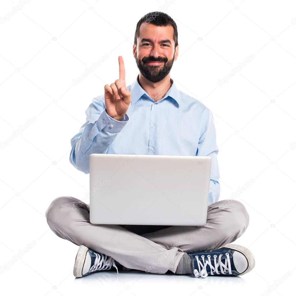 Man with laptop counting one