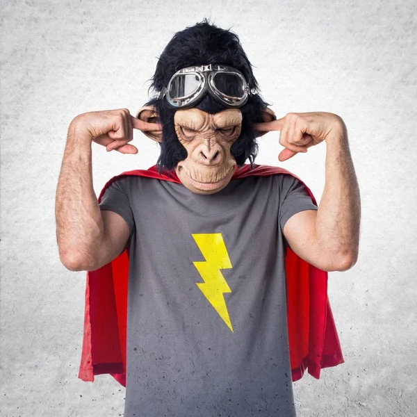 Superhero monkey man covering his ears — Stock Photo, Image