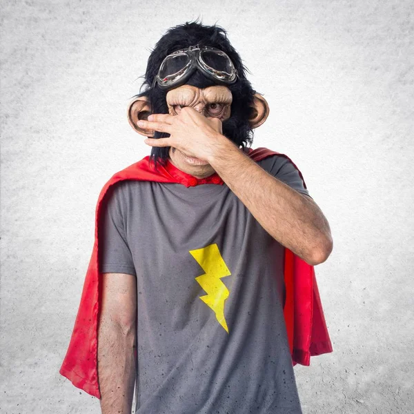 Superhero monkey man making smelling bad gesture — Stock Photo, Image