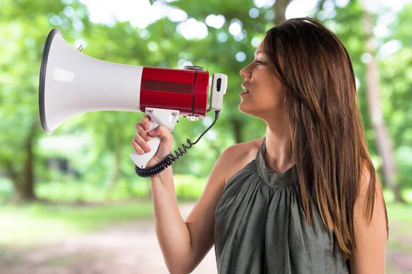 Young girl shouting by megaphone — Stock Photo, Image