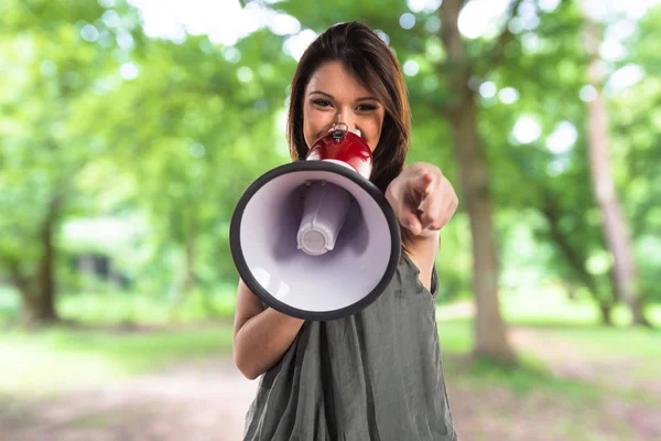 Young girl shouting by megaphone — Stock Photo, Image