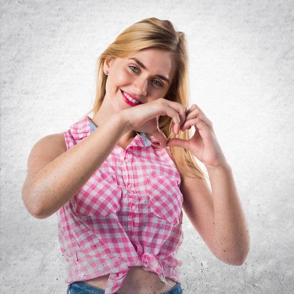 Meisje maken een hart met haar handen — Stockfoto