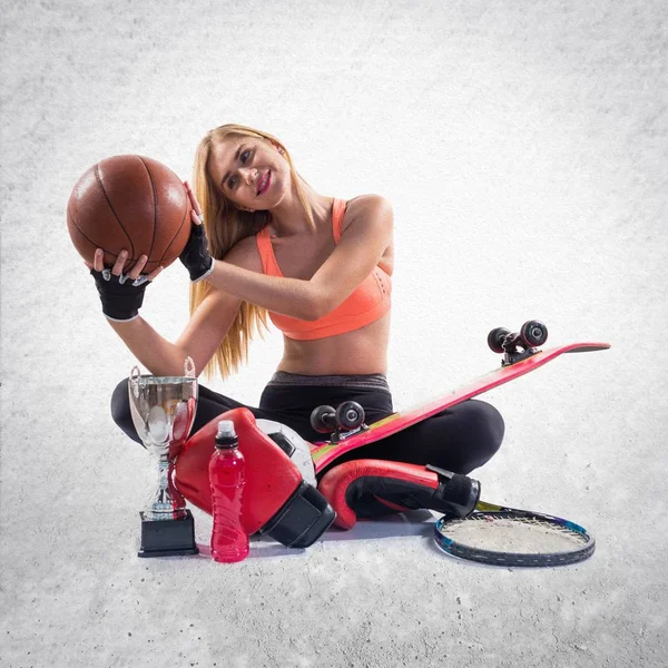 Sport girl with a lot of sport items — Stock Photo, Image