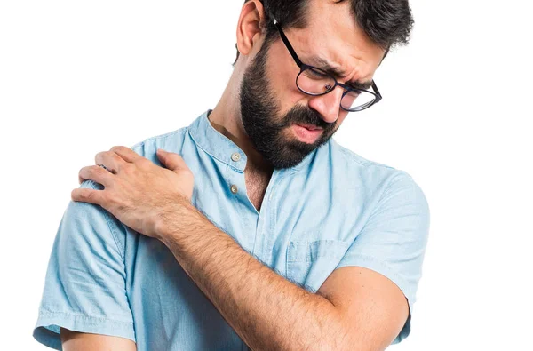 Handsome man with blue glasses with shoulder pain — Stock Photo, Image