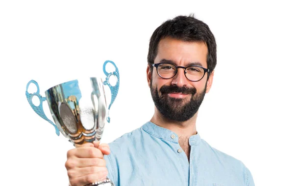 Handsome man with blue glasses holding a trophy — Stock Photo, Image