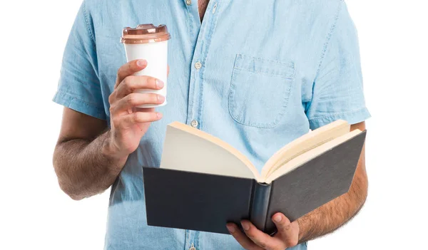 Hombre guapo con gafas azules leyendo libro y bebiendo café —  Fotos de Stock