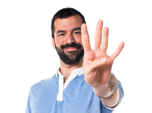 Hombre con camisa azul contando cuatro — Foto de Stock