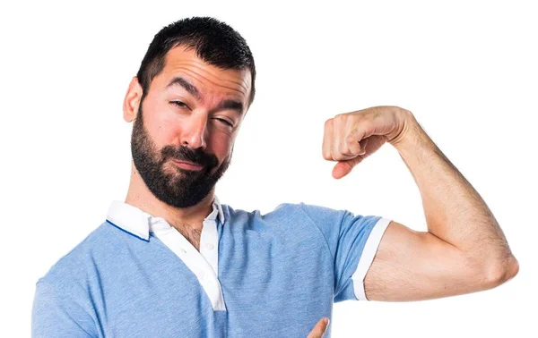 Man with blue shirt making strong gesture — Stock Photo, Image