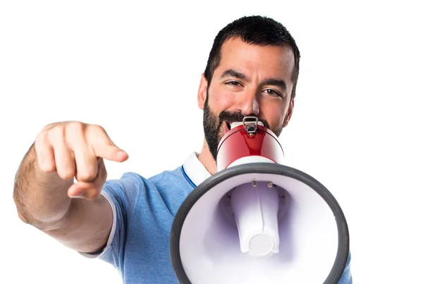 Man with blue shirt shouting by megaphone — Stock Photo, Image