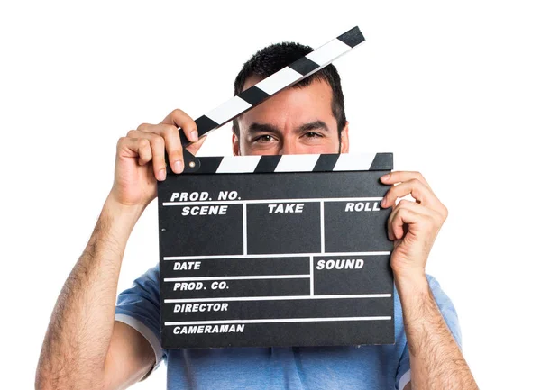 Man with blue shirt holding a clapperboard — Stock Photo, Image