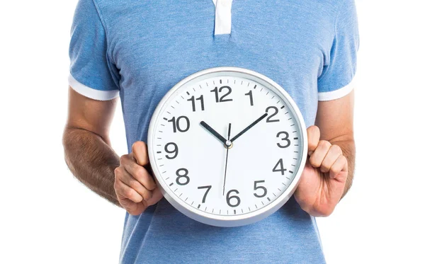 Man with blue shirt holding clock — Stock Photo, Image