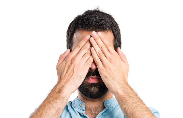 Handsome man covering his eyes — Stock Photo, Image