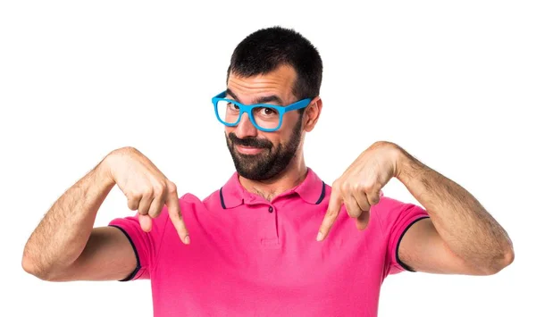 Man with colorful clothes pointing down — Stock Photo, Image