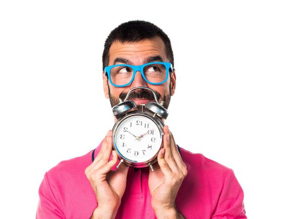 Man with colorful clothes holding vintage clock