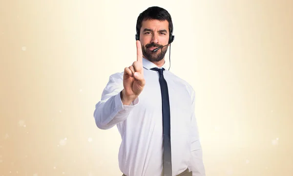 Young man with a headset counting one — Stock Photo, Image