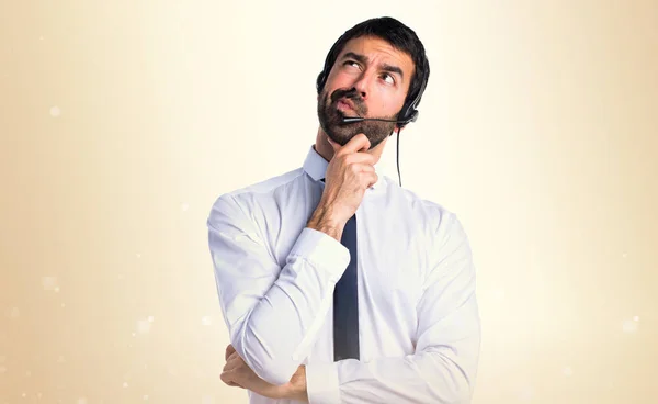 Young man with a headset thinking — Stock Photo, Image