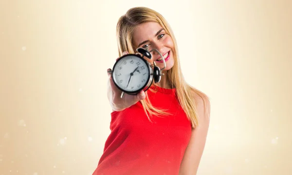 Blonde girl holding vintage clock — Stock Photo, Image