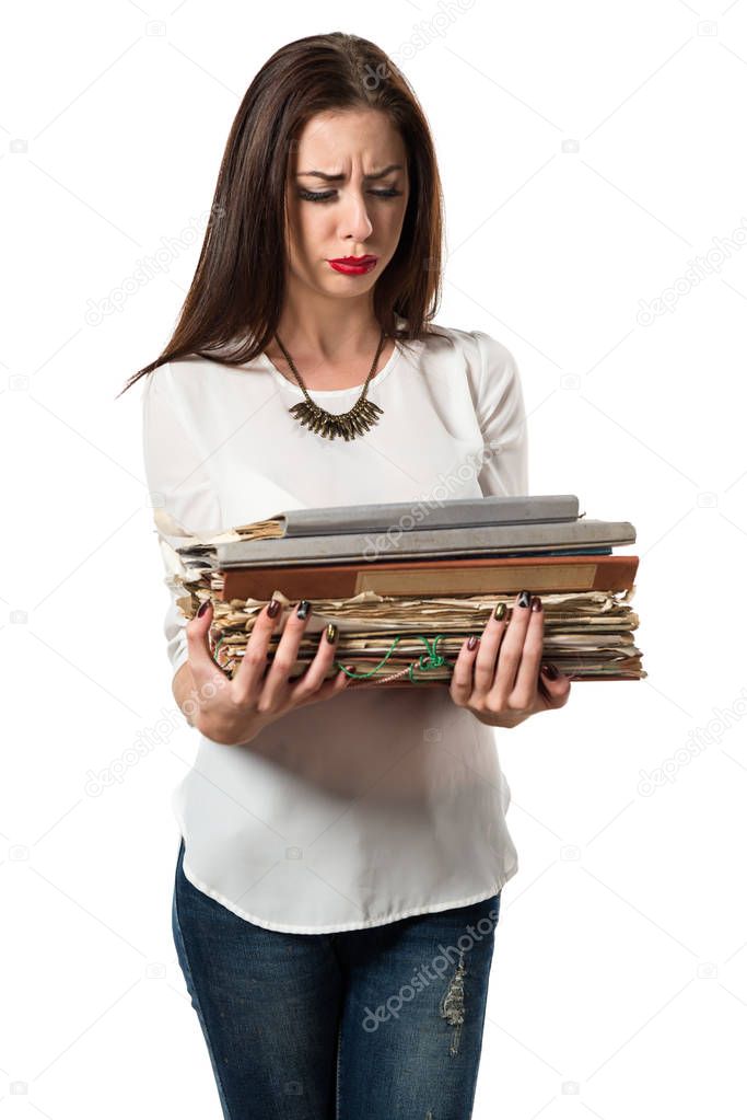 frustrated pretty young girl holding several college notes