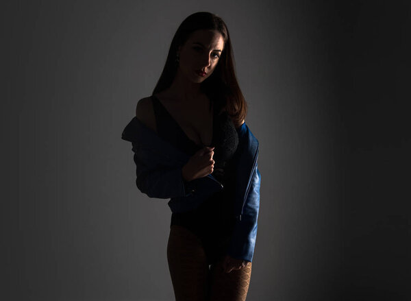 Young pretty model woman posing in studio with blue jacket