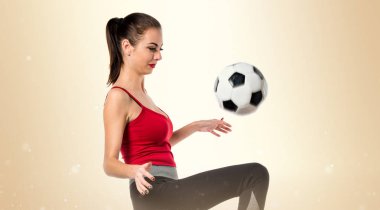 Bir futbol topu tutan güzel spor kadın