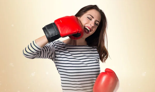 Pretty young girl with boxing gloves