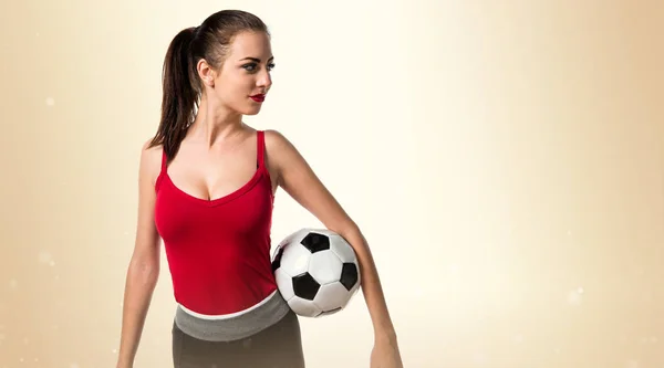 Mulher bonita esporte segurando uma bola de futebol — Fotografia de Stock