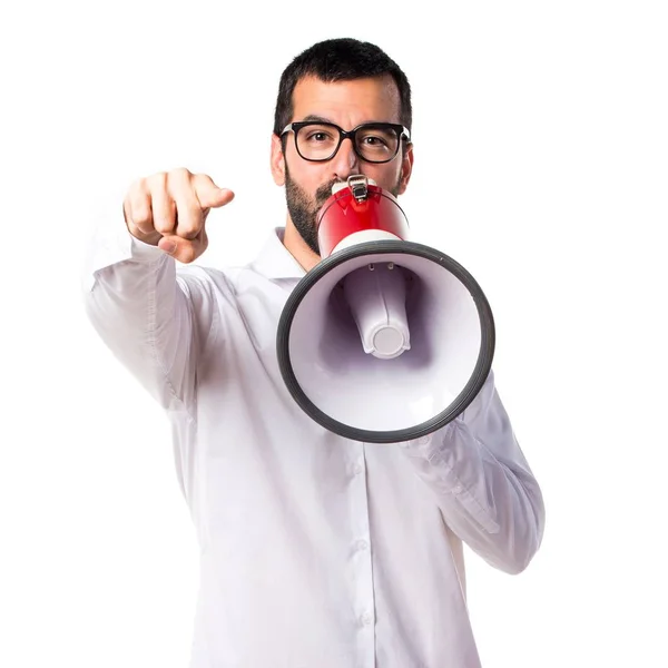 Handsome man with glasses shouting by megaphone — Stock Photo, Image